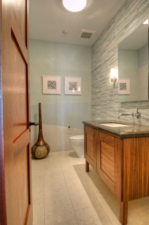 Contemporary Powder Room with Paint 3, Flat panel cabinets, stone tile floors, Flush, Complex marble counters, Paint 1