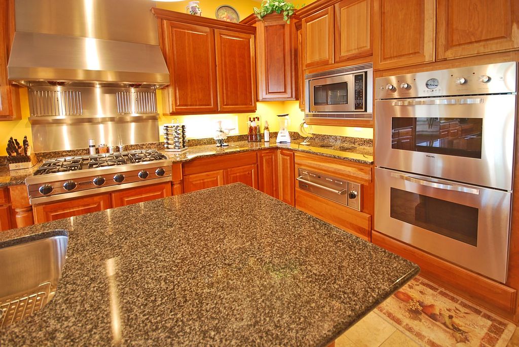 Traditional Kitchen with double wall oven, Undermount sink, Wall Hood, Framed Partial Panel, Standard height, Stainless Steel