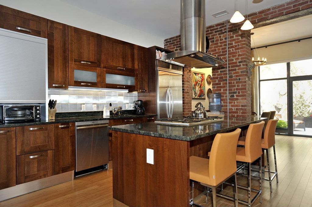 Modern Kitchen with U-shaped, full backsplash, Large Ceramic Tile, Built-in bookshelf, Transom window, Pendant light