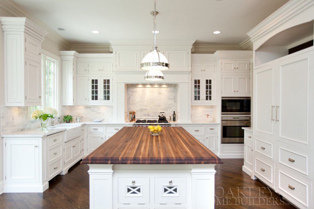 Traditional Kitchen with Custom hood, Complex Marble Tile, Flat panel cabinets, Pendant light, Simple granite counters, Paint