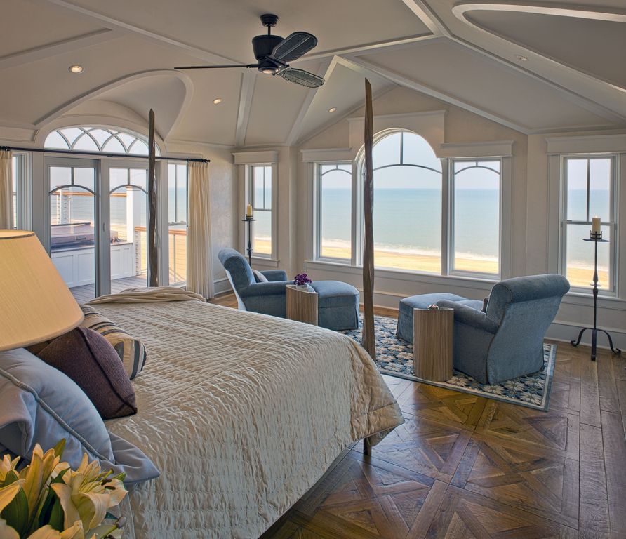 Traditional Master Bedroom with Hardwood floors, can lights, sliding glass door, Parquet wood floor, Ceiling fan