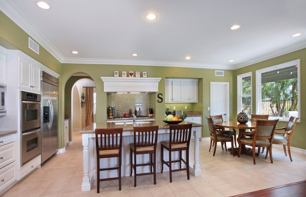 Traditional Kitchen with Simple granite counters, six panel door, MS International Crema Caramel Granite, double-hung window
