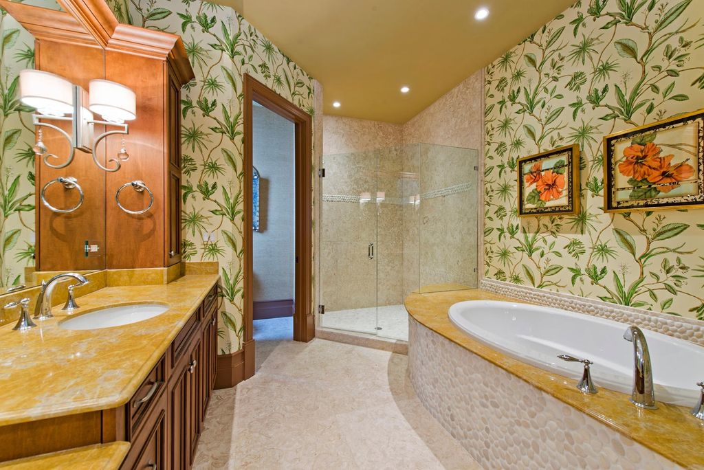 Tropical Master Bathroom with Onyx, drop in bathtub, Pental - jurastone beige polished limestone tile, interior wallpaper