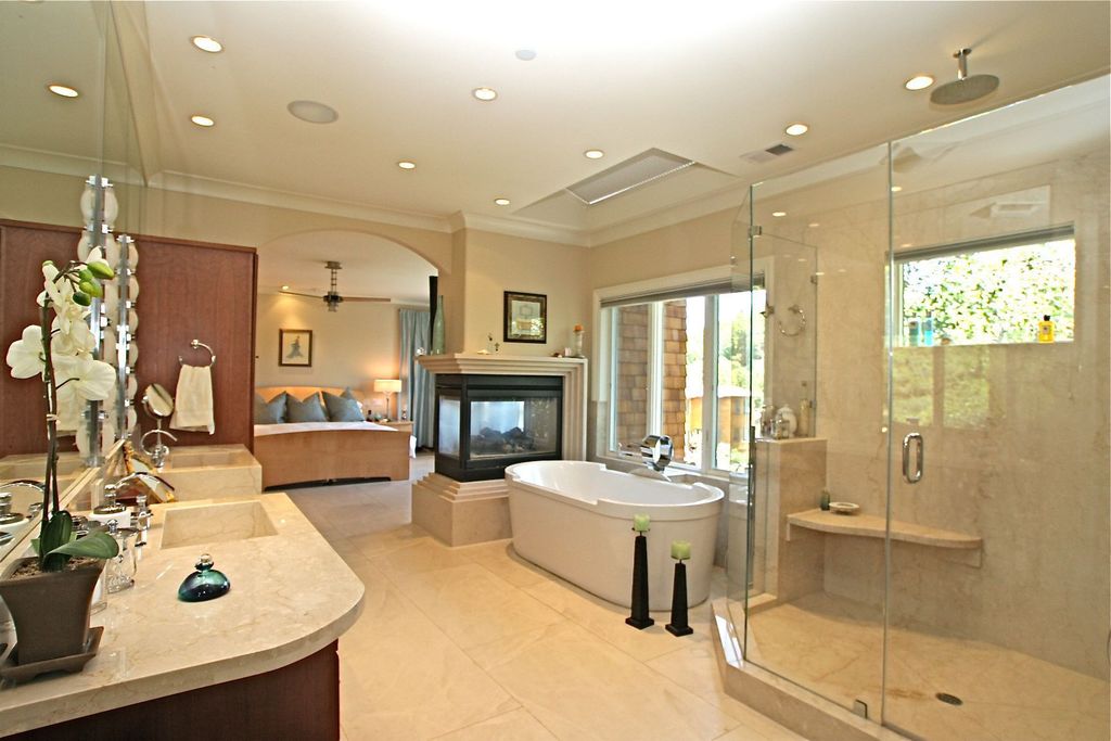 Contemporary Master Bathroom with Fireplace, Soaking, bathroom sink, Complex marble counters, Undermount sink, Double sink