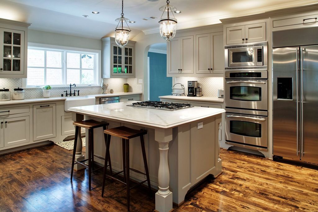 Traditional Kitchen with Hardwood floors, Farmhouse sink, Crown molding, single dishwasher, Built In Refrigerator, Casement