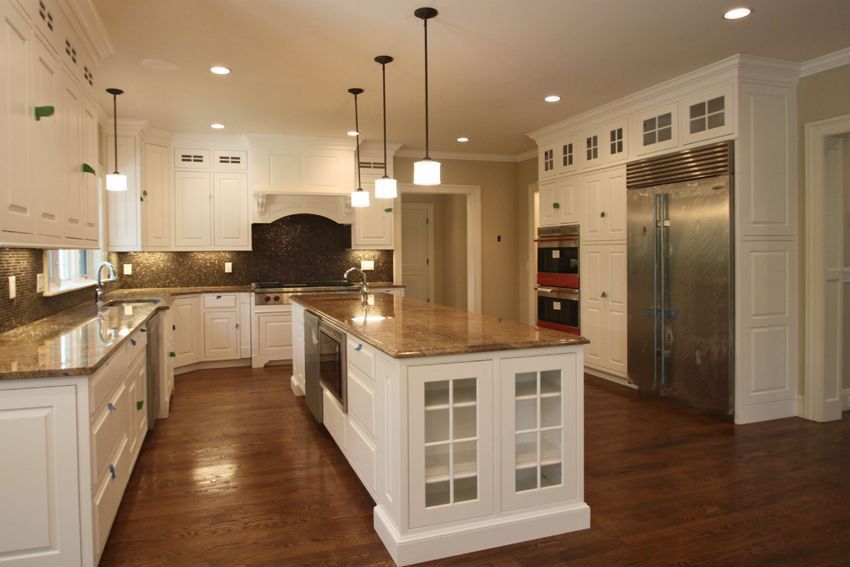 Traditional Kitchen with double wall oven, two dishwashers, Pendant light, Framed Partial Panel, Simple granite counters
