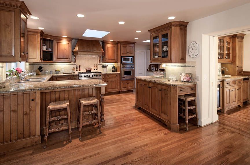 Country Kitchen with Standard height, Limestone Tile, Hardwood floors, built-in microwave, Butlers pantry, wall oven, Paint