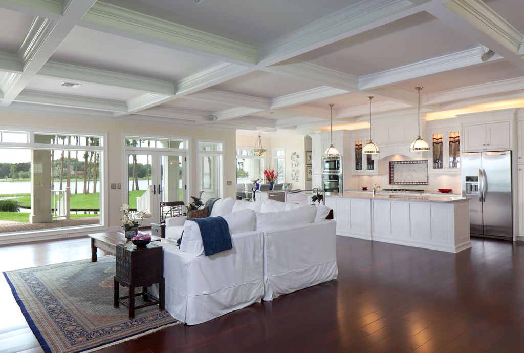 Traditional Great Room with Pendant light, Hardwood floors, Paint 1, French doors, Surya adana navy blue/red area rug