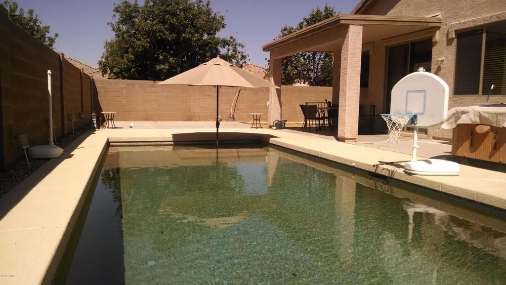Mediterranean Swimming Pool with exterior tile floors, Stone/brick fence, exterior concrete tile floors, Fence, Casement