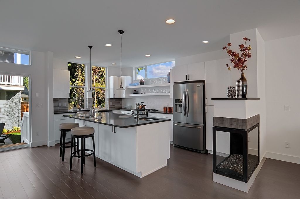 Contemporary Kitchen with Multiple Refrigerators, Pendant light, Casement, Undermount sink, can lights, gas range, Flush