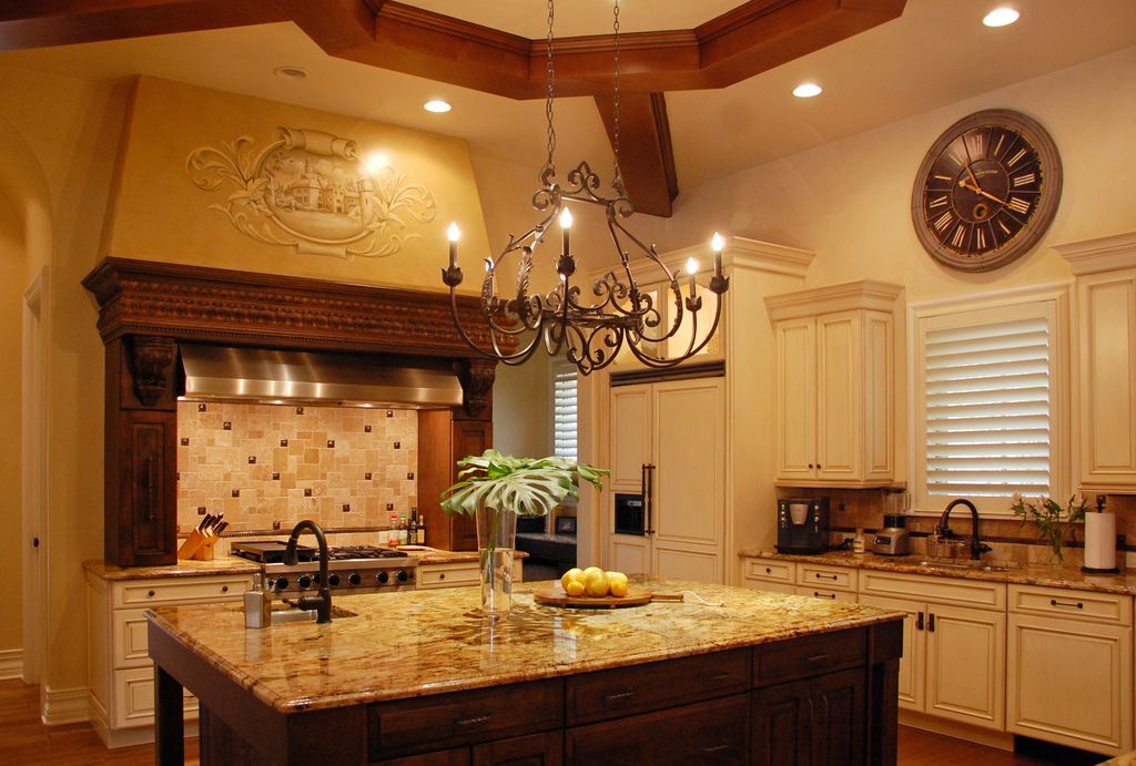 Mediterranean Kitchen with electric cooktop, Chandelier, Stone Tile, Raised panel, MS International Granite Namibian Gold