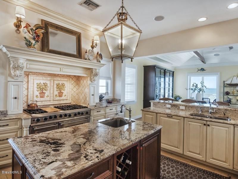 Traditional Kitchen with double-hung window, Wall sconce, Framed Partial Panel, Standard height, Custom hood, Kitchen island