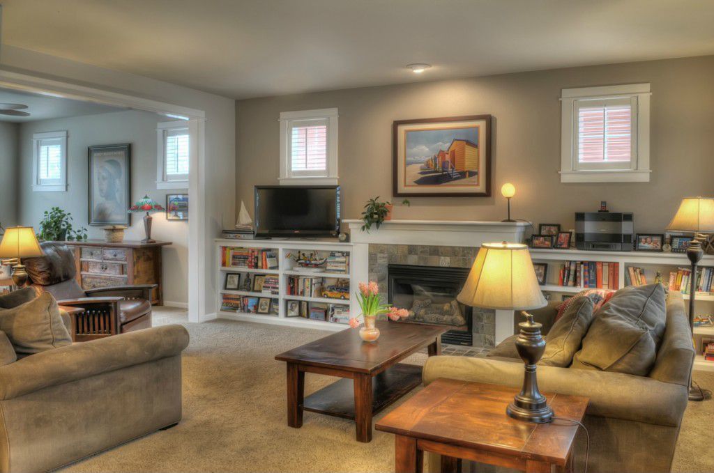 Traditional Living Room with Standard height, Carpet, Built-in bookshelf, Fireplace, stone fireplace, Casement, can lights