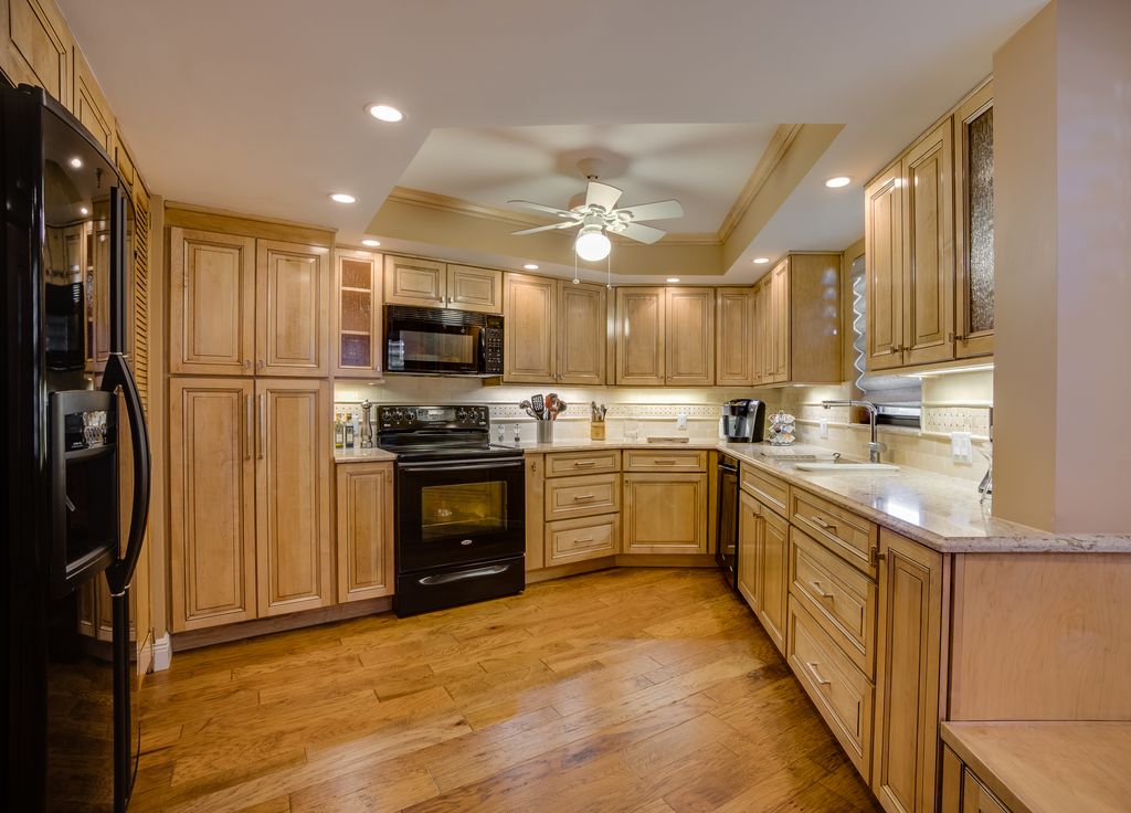 Craftsman Kitchen with gas range, Ceiling fan, flush light, Raised panel, Glass panel, Complex marble counters, Stone Tile