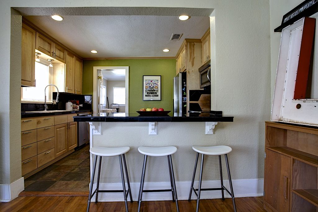 Cottage Kitchen with Drop-in sink, slate tile floors, Paint 1, Crown molding, Stone Tile, European Cabinets, Breakfast bar