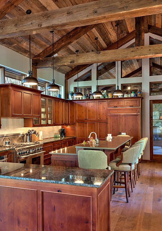 Country Kitchen with Simple granite counters, Limestone Tile, Custom hood, Exposed beam, Kitchen island, U-shaped, Flush