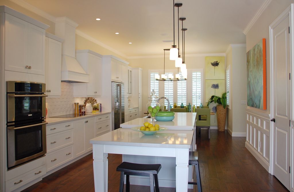 Contemporary Kitchen with specialty window, Built In Refrigerator, can lights, full backsplash, double wall oven, Custom hood