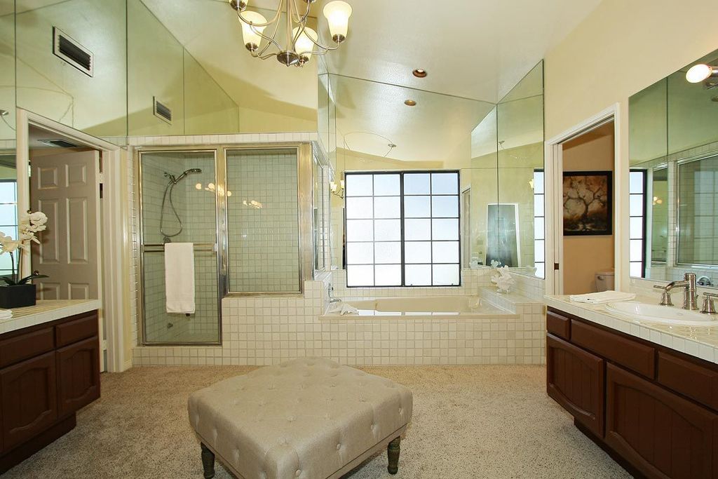Traditional Master Bathroom with Shower, Chandelier, Bathtub, framed showerdoor, Drop-in sink, large ceramic tile counters
