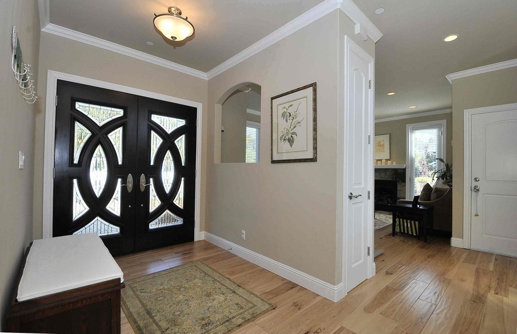 Traditional Entryway with Hardwood floors, flush light, specialty door, Standard height, French doors, Crown molding, Paint