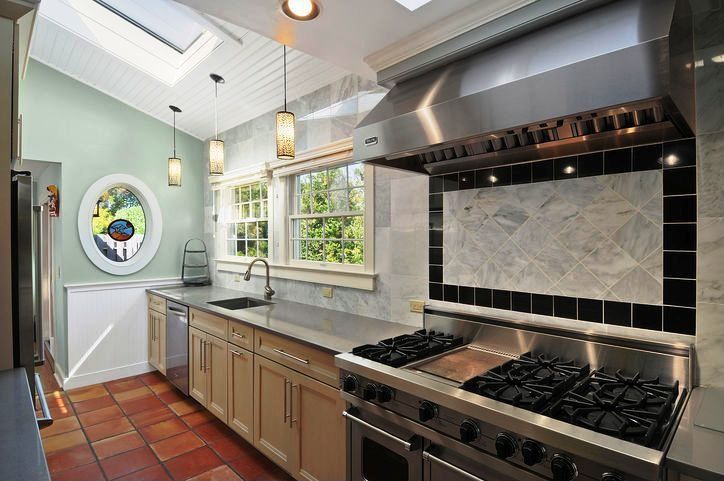 Contemporary Kitchen with Gray quartz countertop, Skylight, European terra cotta tile flooring, Slate counters, can lights