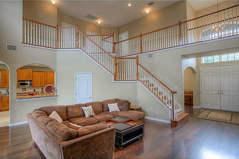 Traditional Living Room with Balcony, Hardwood floors, specialty door, High ceiling, Columns