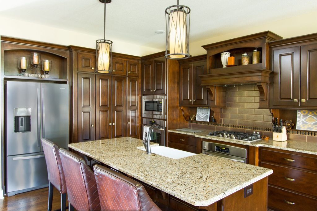 Traditional Kitchen with wall oven, Inset cabinets, Pendant light, Breakfast bar, Farmhouse sink, Subway Tile, Custom hood
