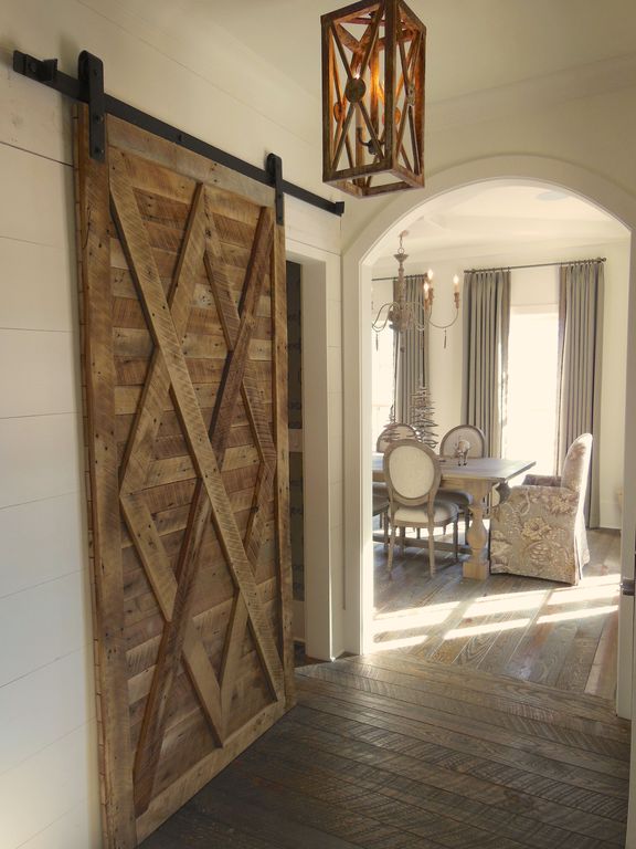Country Hallway with Arch doorway, Barn door, Upholstered dining chair, Paint, Standard height, Crown molding, Chandelier