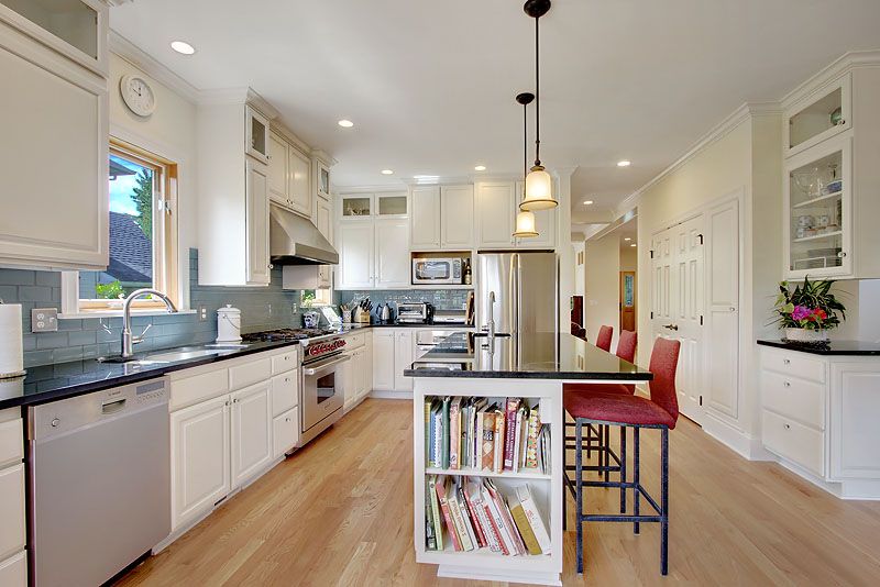 Traditional Kitchen with Framed Partial Panel, Standard height, Wall Hood, full backsplash, Glass panel, U-shaped, can lights