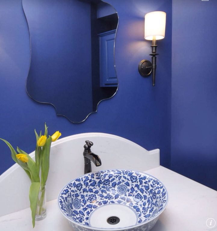 Traditional Powder Room with Powder room, Raised panel, Corian counters, Vessel sink, Wall sconce, partial backsplash, Paint