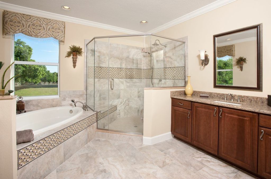 Contemporary Master Bathroom with Handheld showerhead, stone tile floors, drop in bathtub, picture window, Inset cabinets