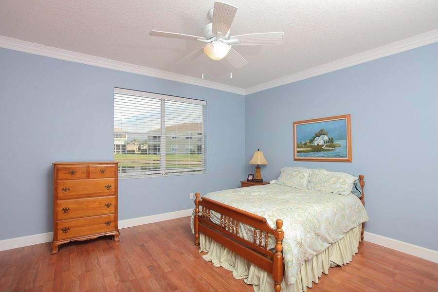 Traditional Guest Bedroom with Standard height, double-hung window, Crown molding, Ceiling fan, Hardwood floors