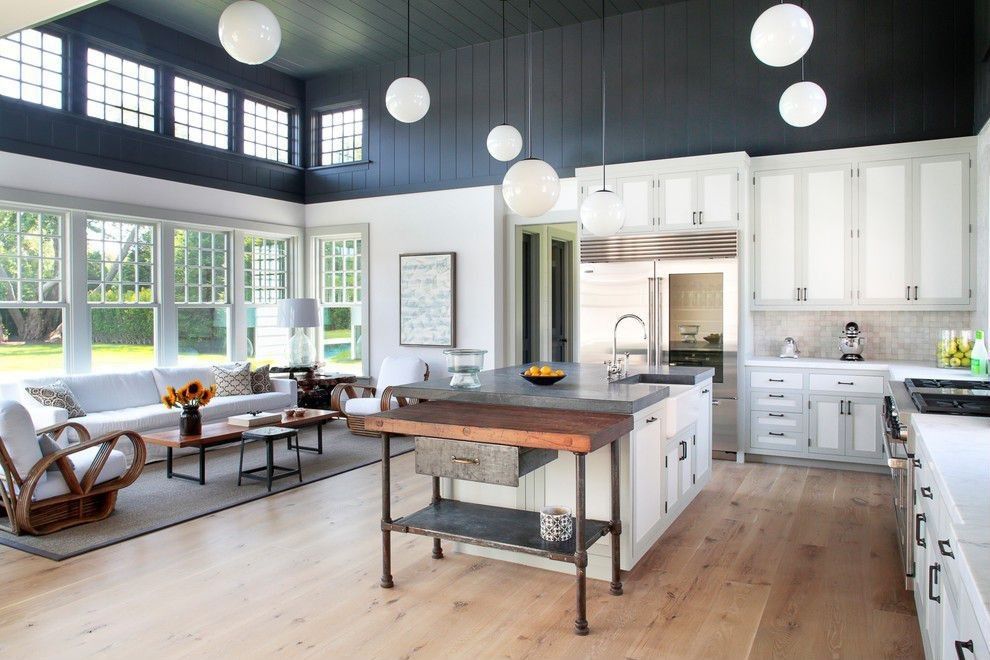 Country Kitchen with L-shaped, Flat panel cabinets, Pental aspen honed marble, Hardwood floors, Simple marble counters