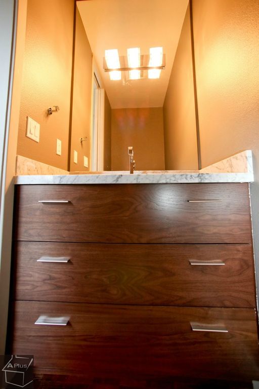 Modern Powder Room with Complex marble counters, Complex Marble, European Cabinets, Standard height, Undermount sink, Flush