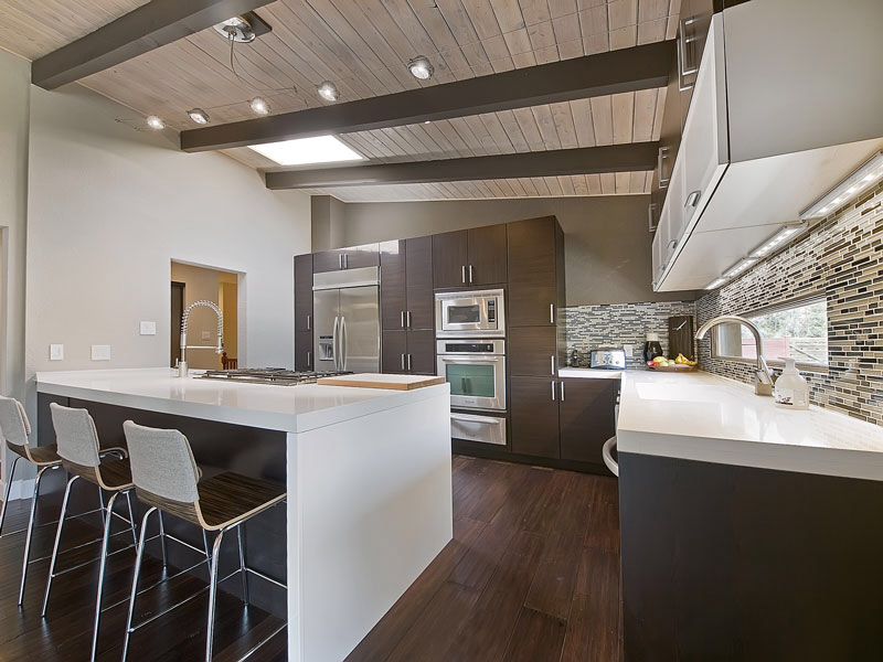 Contemporary Kitchen with full backsplash, European Cabinets, Built In Refrigerator, Skylight, wall oven, Standard height