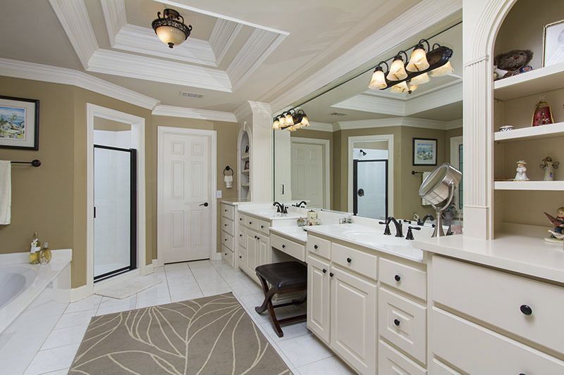 Traditional Master Bathroom with stone tile floors, Corian counters, Master bathroom, limestone tile floors, six panel door