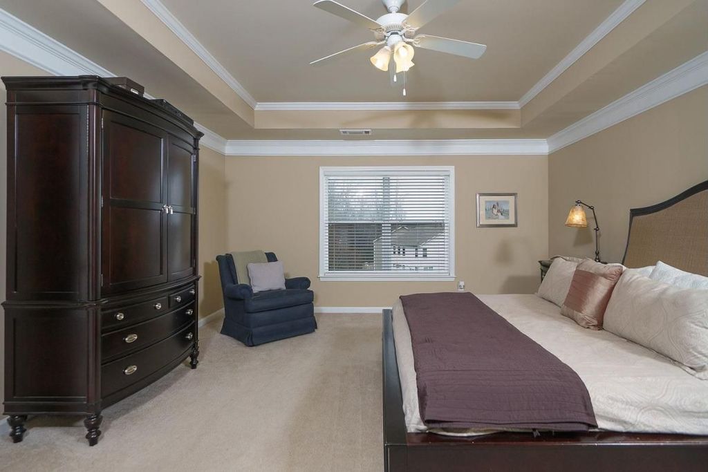 Traditional Master Bedroom with Crown molding, Standard height, Carpet, Built-in bookshelf, double-hung window, Ceiling fan