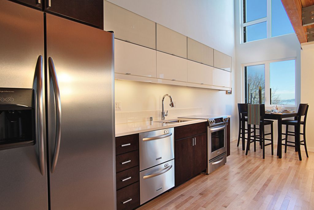 Contemporary Kitchen with Built In Refrigerator, double dishwasher, European Cabinets, Corian counters, Breakfast nook, Flush