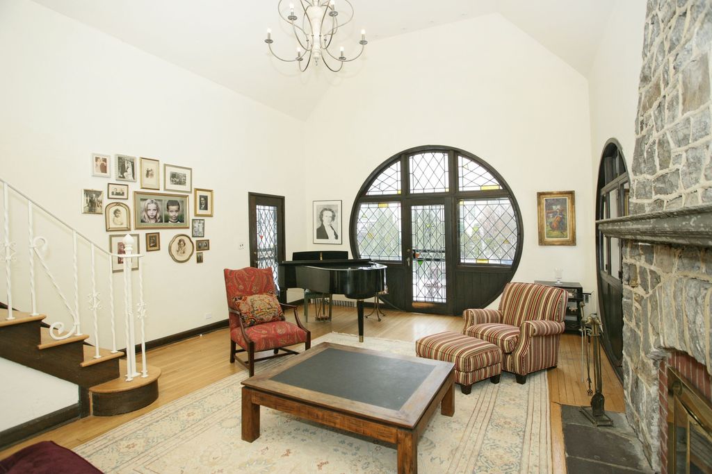 Traditional Living Room with Transom window, Rounded back chair, Cascade Chandelier, High ceiling, Fireplace, Hardwood floors