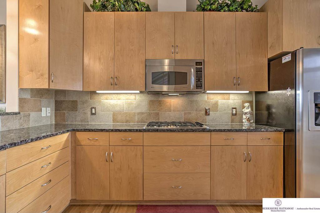 Contemporary Kitchen with flush light, Complex granite counters, L-shaped, Built In Refrigerator, electric cooktop, Flush
