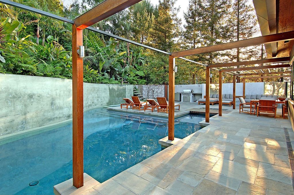 Contemporary Swimming Pool with Outdoor kitchen, exterior stone floors, Other Pool Type, Fence